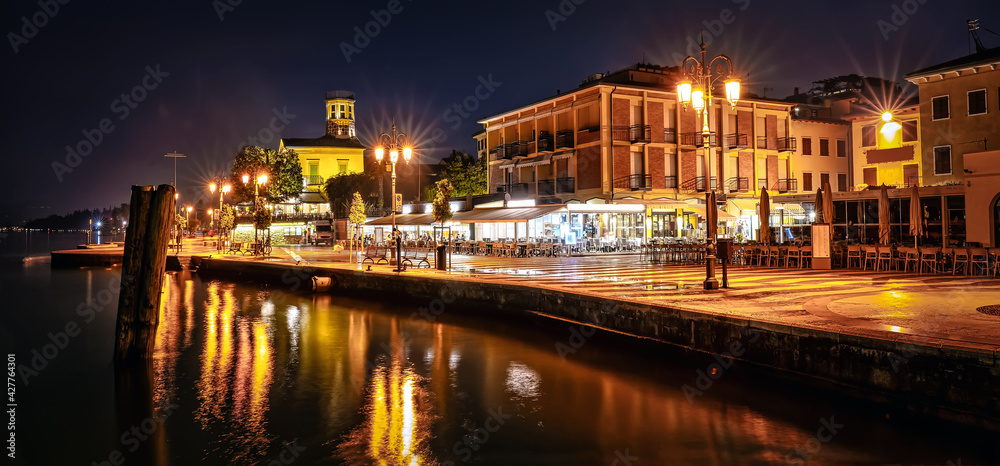 Promenade of Lazise at night. The town is a popular holiday destination in Garda Lake district.