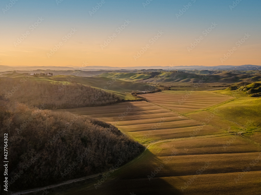Scenic tuscan countryside in winter at sunset. 