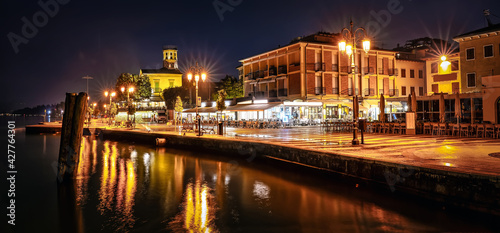 Promenade of Lazise at night. The town is a popular holiday destination in Garda Lake district.