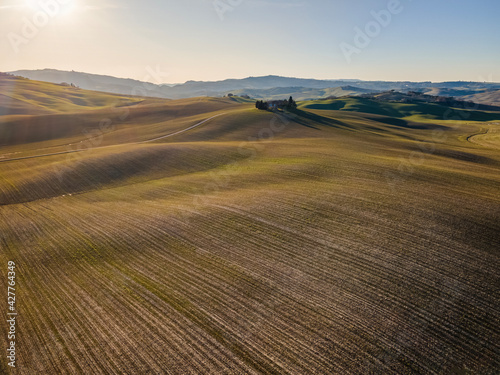 Idyllic countryside landscape at sunset in winter season. Drone shot. Aerial view.