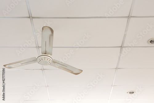 Old white ceiling fans on the ceiling of the room  and copy space