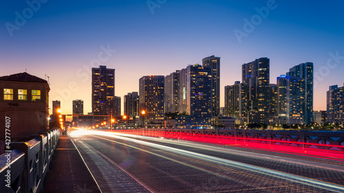 Miami city skyline with moving traffic light trails at night, Florida