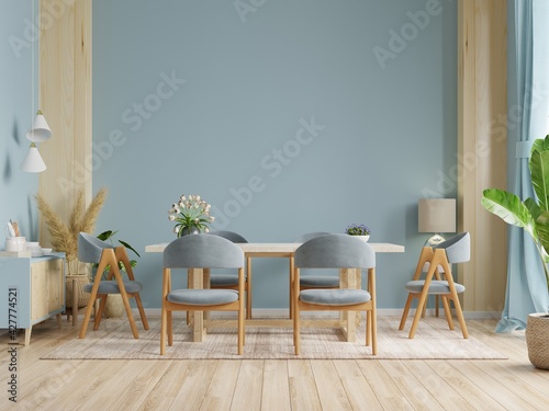 Modern dining room interior design with dark blue color wall.