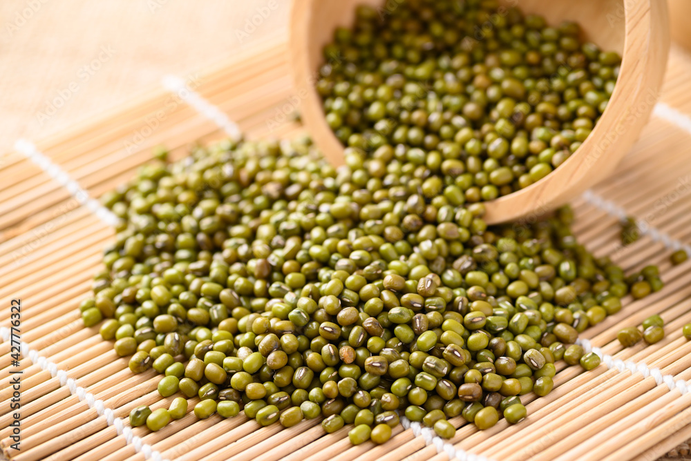 Pile of mung bean seeds in a wooden bowl, Food ingredients in Asian cuisine and produce mung bean sprout Pile of mung bean seeds in a wooden bowl, Food ingredients in Asian cuisine and produce mung bean sprout