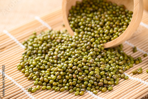 Pile of mung bean seeds in a wooden bowl, Food ingredients in Asian cuisine and produce mung bean sprout photo