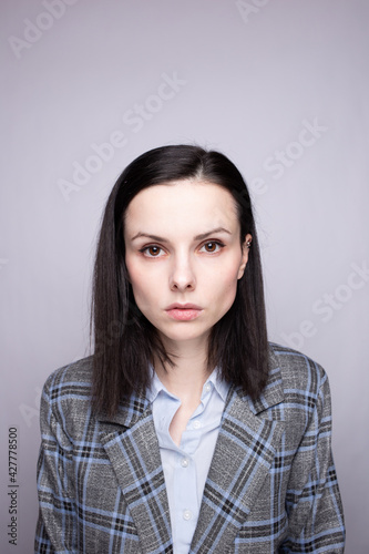 woman manager in suit on gray background