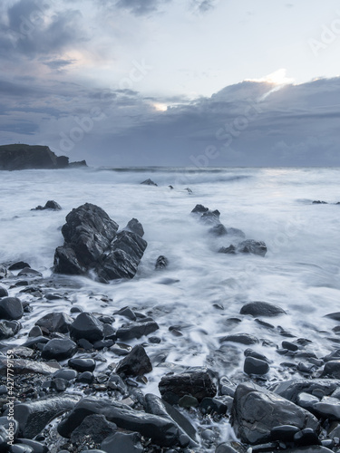 Rocky seascape view in cloudy morning.