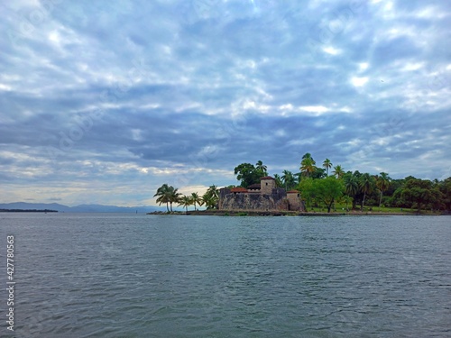 View from the water of the Castillo de San Felipe de Lara in cloudy day, Livingston, Izabal, Guatemala. Vacation concept