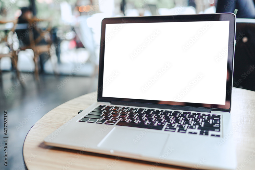 Laptop with Mock up blank screen on wooden table in front of cafe space for text. product display montage- technology concept. Laptop with Mock up blank screen on wooden table in front of cafe space for text. product display montage- technology concept.