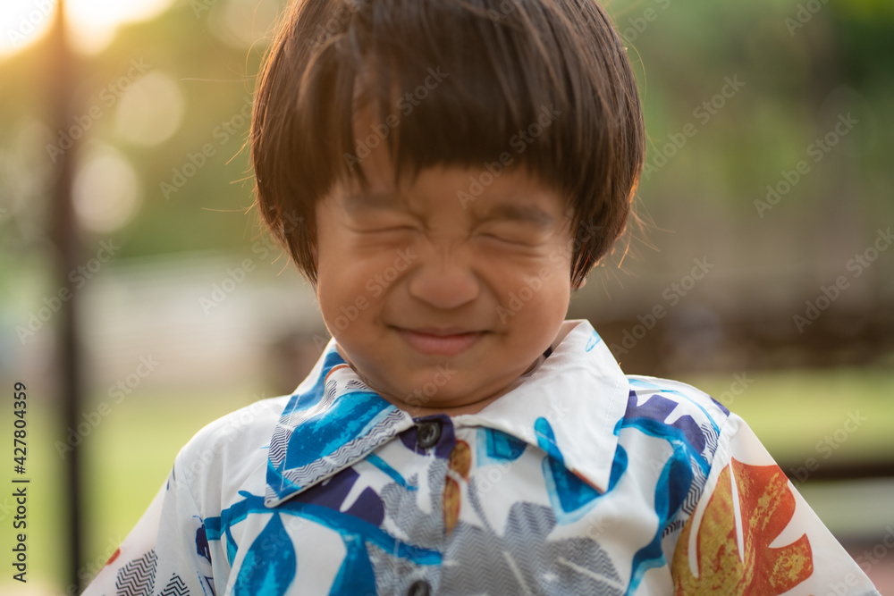 Adorable little asian boy smiling while playing outdoor park sunset light Adorable little asian boy smiling while playing outdoor park sunset light
