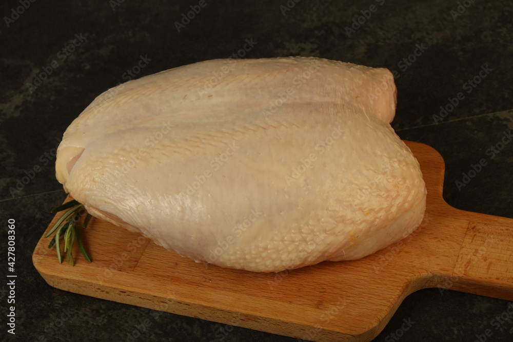 Raw whole chicken breast with skin Raw whole chicken breast with skin
