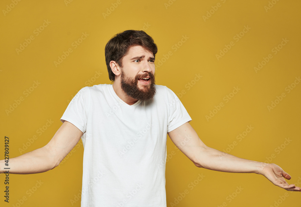 male model gesturing with his hands on a yellow background cropped view male model gesturing with his hands on a yellow background cropped view