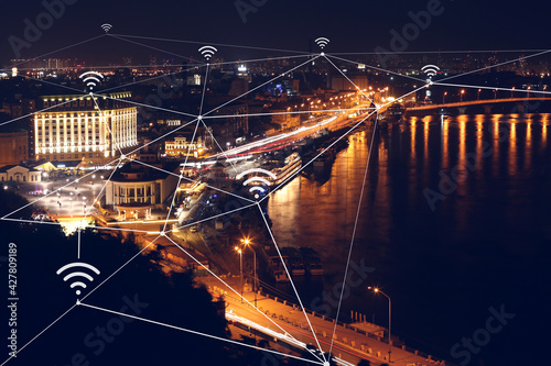 View of modern illuminated city at night. Concept of internet