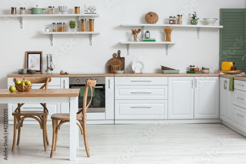 Dining table and chairs in interior of modern kitchen