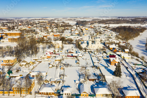Aerial view of Russian town of Venyov overlooking temple complex of former Epiphany monastery on sunny winter day
