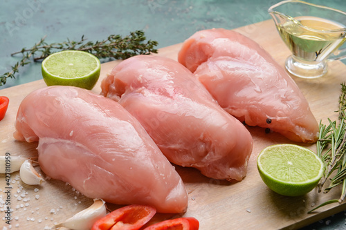 Board with raw chicken fillet, closeup