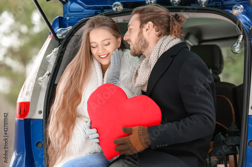 Happy young couple with red...