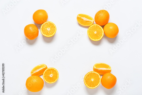 Ripe tasty oranges on white background