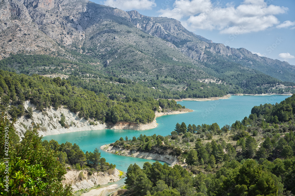 An idyllic lake between mountains.Guadalest reservoir in Alicante, Spain.