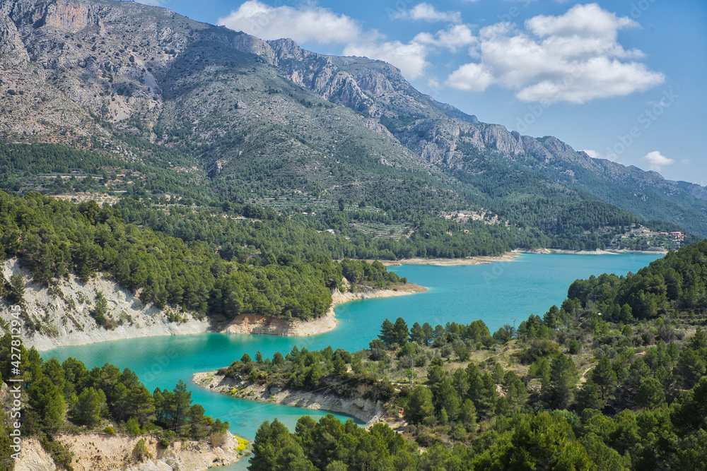 An idyllic lake between mountains.Guadalest reservoir in Alicante, Spain.