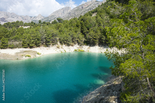 An idyllic lake between mountains.Guadalest reservoir in Alicante, Spain.
