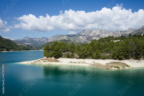 An idyllic lake between mountains.Guadalest reservoir in Alicante, Spain. © ruthlaguna