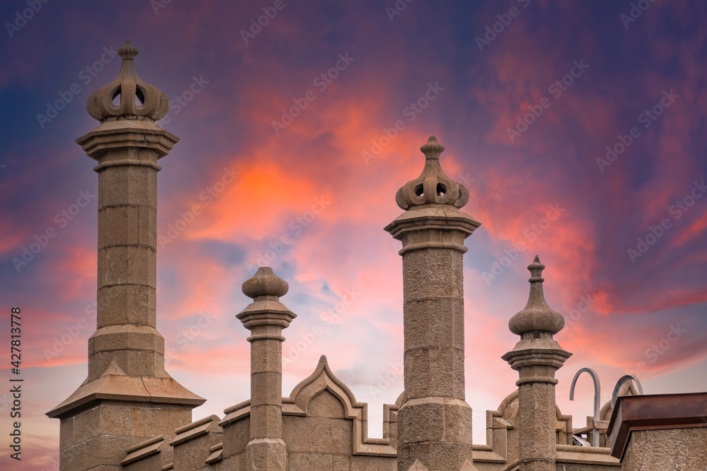 The walls and towers of the old palace on the background of beautiful pink sunset