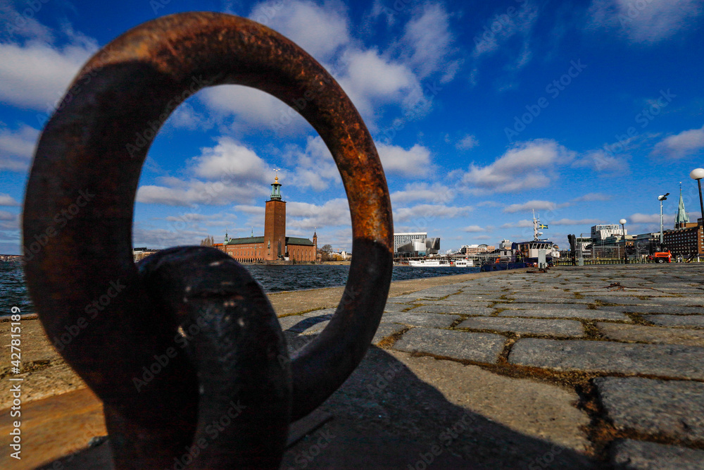 Fototapeta premium Stockholm, Sweden The City Hall or Stadshuset seen through a ring on the quayside.