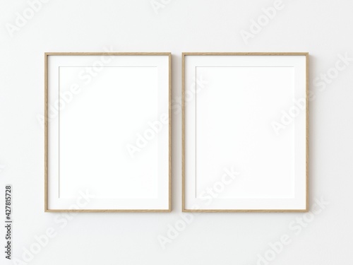 Two light wood thin rectangular vertical frame hanging on a white textured wall mockup  Flat lay  top view  3D illustration