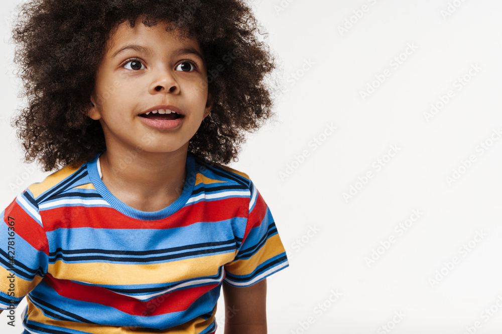 Smiling little child in everyday clothes over wall background Smiling little child in everyday clothes over wall background
