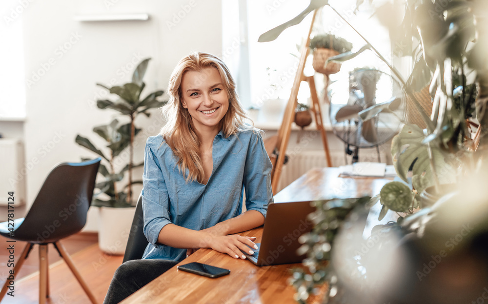 Positive business woman and her occupation in cosy office in daytime Positive business woman and her occupation in cosy office in daytime