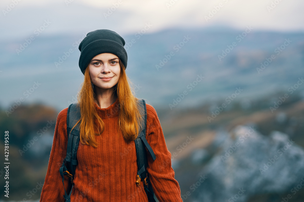 pretty woman tourist with backpack in autumn clothes mountains walk