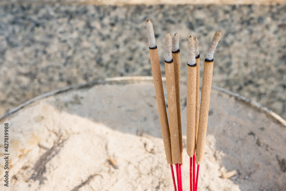 Incense sticks and ashes in incense burner close up.One of the factors causing PM2.5 dust problems in Thailand.
