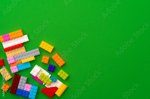 Details of kids plastic constructor on green background © fotofabrika