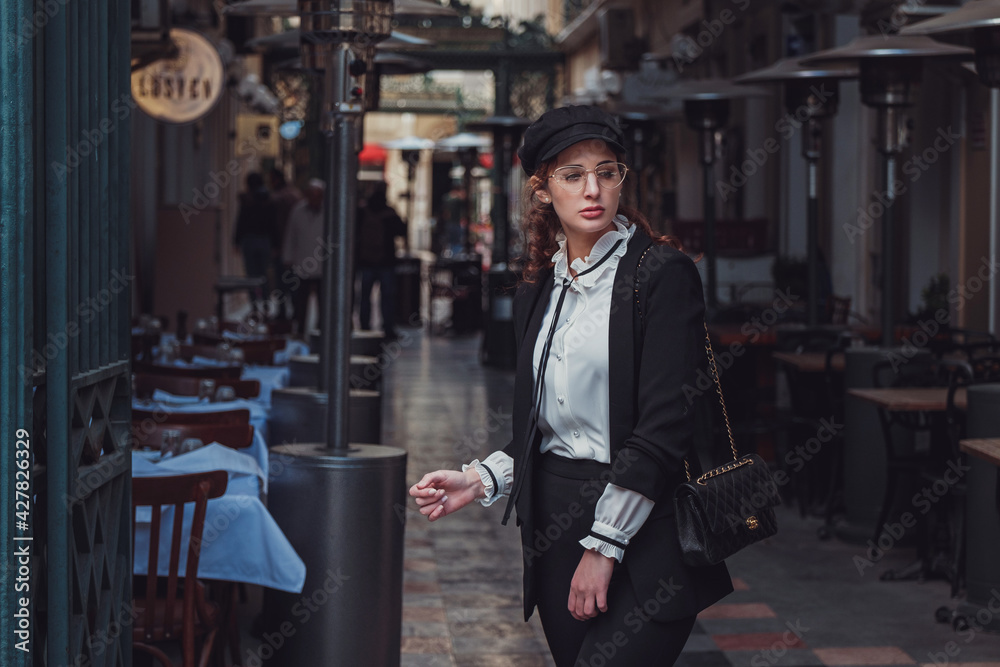 Fototapeta premium Beautiful stylish young woman walking the atmospheric streets of Istanbul