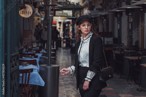 Beautiful stylish young woman walking the atmospheric streets of Istanbul