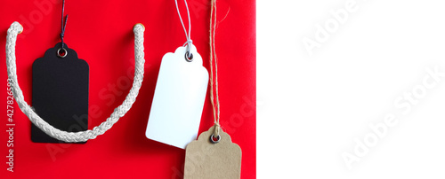 Price tags on red shopping bag on a white background photo