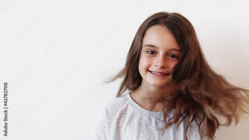 Happy child. Carefree lifestyle. Innocent beauty. Enthusiastic playful joyful smiling cute little girl turning around dancing with flying hair isolated on white background. Happy child. Carefree lifestyle. Innocent beauty. Enthusiastic playful joyful smiling cute little girl turning around dancing with flying hair isolated on white background.