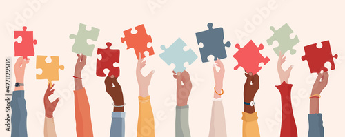 Autism syndrome concept. Group of raised arms of diverse people holding a jigsaw piece. Learning support and education. Neurological Disease. Mind and brain. Sharing. Conceptual
