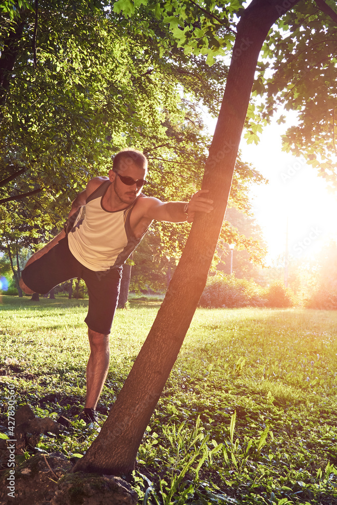 Sporty young adult man training in the park. Sporty young adult man training in the park.