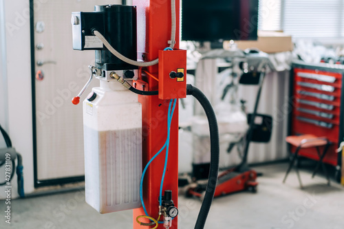 Slika na platnu Car lift standing at the service station. Car repair equipment