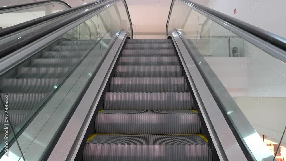 Modern luxury escalators with staircase, Low Angle View Of Escalator At mall Modern luxury escalators with staircase, Low Angle View Of Escalator At mall