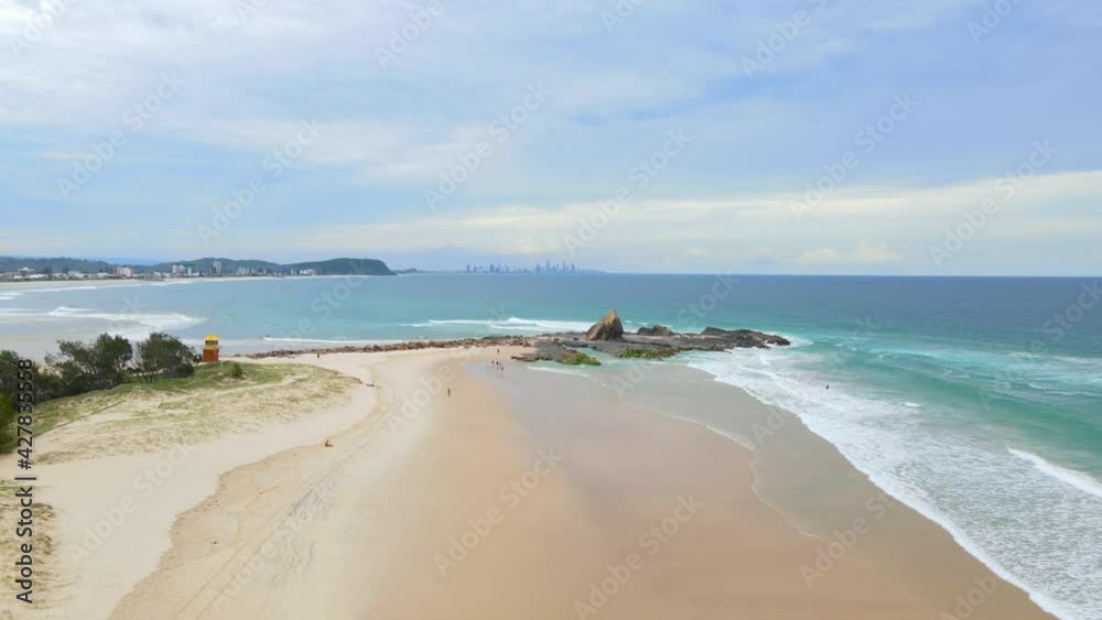 Few People Walking At Sandy Shore Of Currumbin Beach With Seascape - Beach At Gold Coast, QLD, Australia. - aerial Few People Walking At Sandy Shore Of Currumbin Beach With Seascape - Beach At Gold Coast, QLD, Australia. - aerial