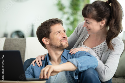 loving couple in living-room using a laptop