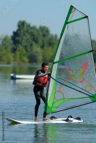 man windsurfing in a lac