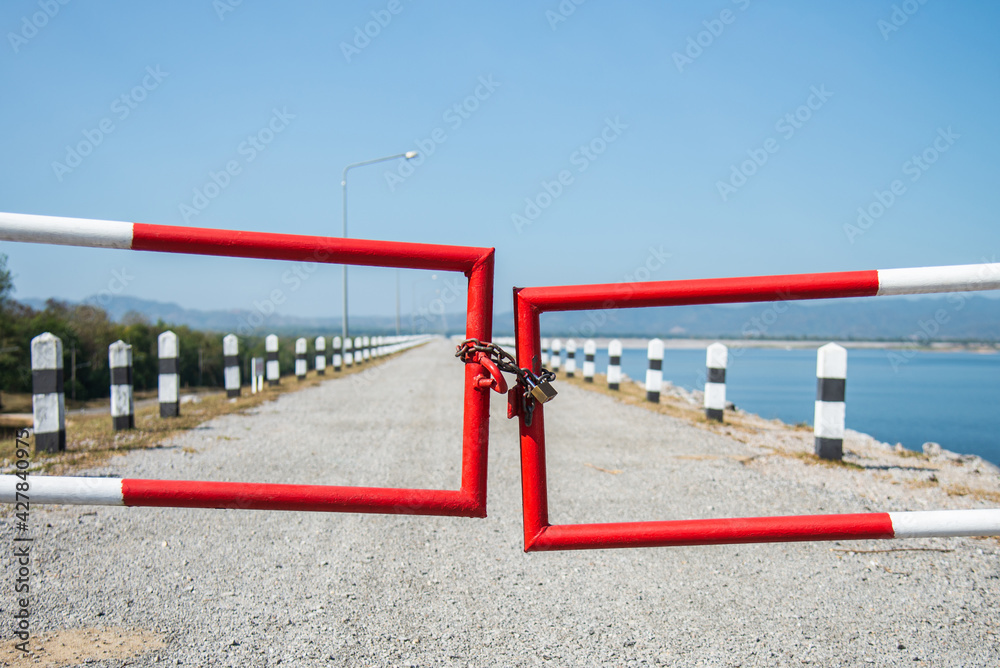 White and red steel fence gate with lock for prohibit concept area White and red steel fence gate with lock for prohibit concept area