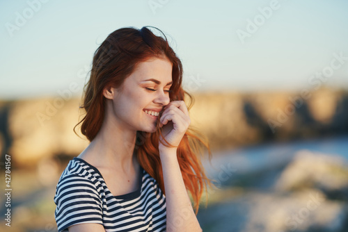 happy woman in striped t-shirt red hair model smile
