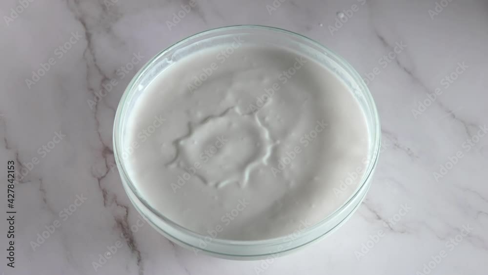 Cherry Tomatoes Fall Into Yogurt. Slow Motion Cherry Tomatoes Fall Into Yogurt. Slow Motion