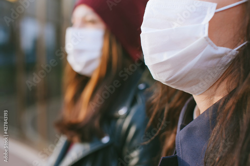 Close-up, mask on a man on the background of a girl with a mask in the distance.