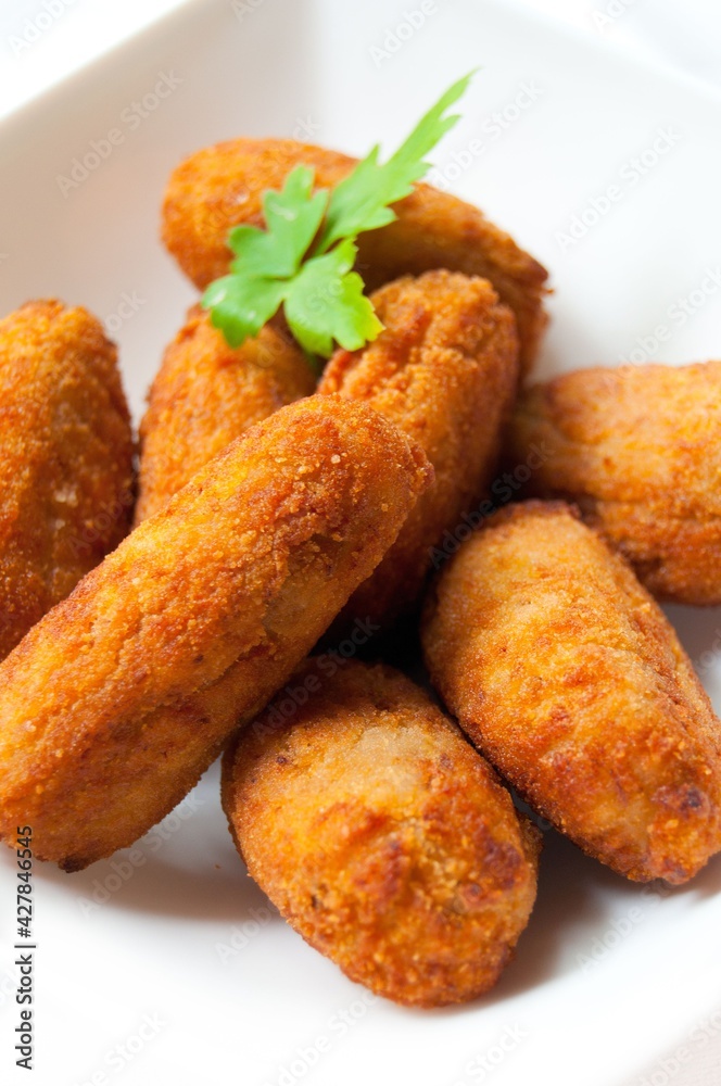 various homemade croquettes on a white plate. Spanish typical food various homemade croquettes on a white plate. Spanish typical food